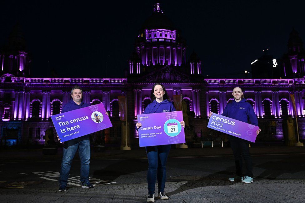 Dr David Marshall (left), Shauna Dunlop and Conor McKiernan posing in front of Belfast City Hall to promote the census