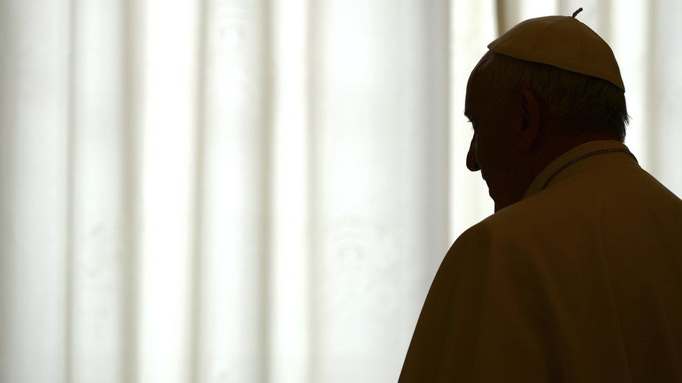 Pope Francis is silhouetted during a meeting with the Samoan Prime Minister