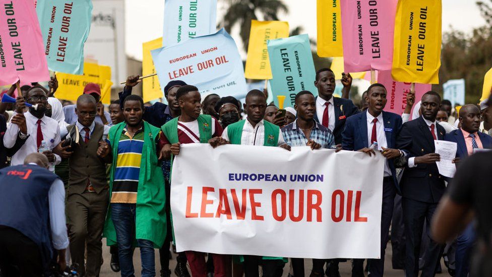 Members of the Uganda National Students Association hold up signs reading "European Union Leave Our Oil"