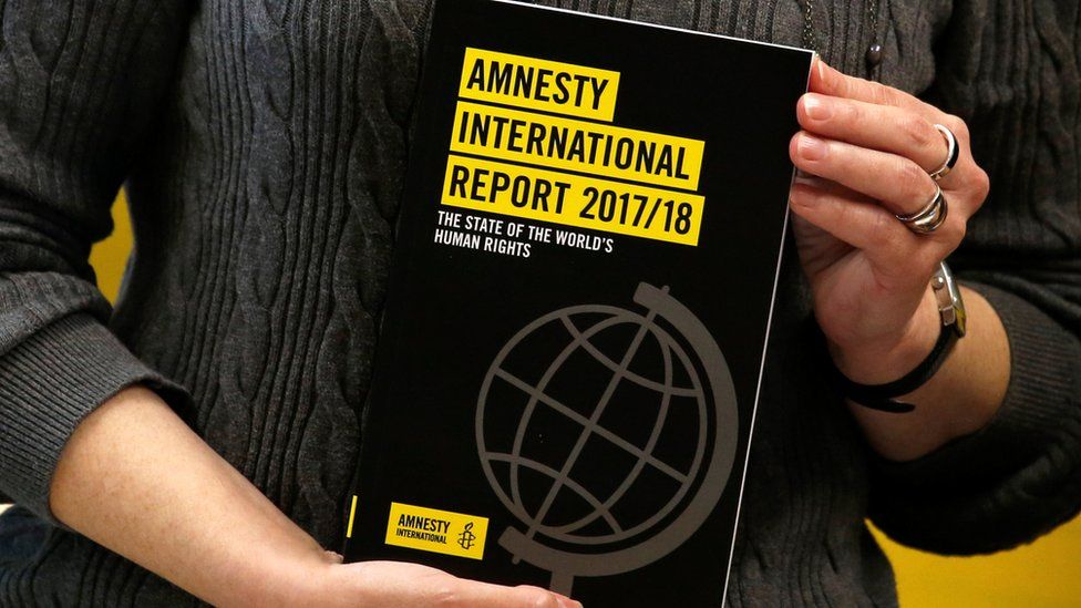 A copy of the Amnesty International Report 2017/18 is shown at a news conference in Hong Kong, China February 22, 2018