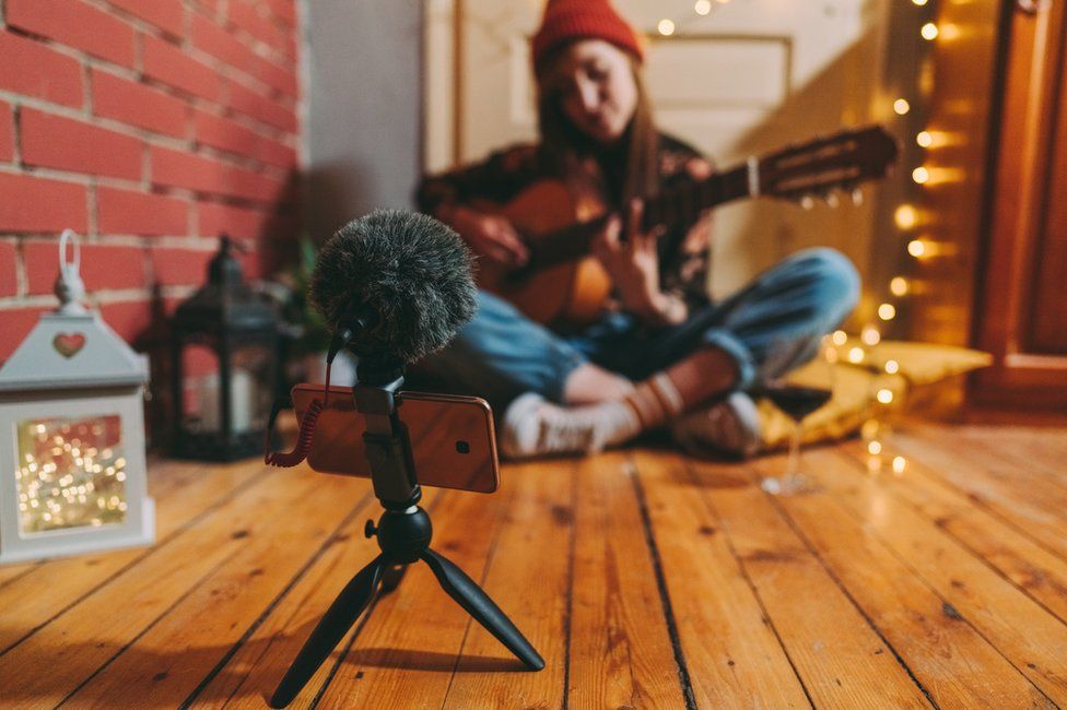 A musician recording at home