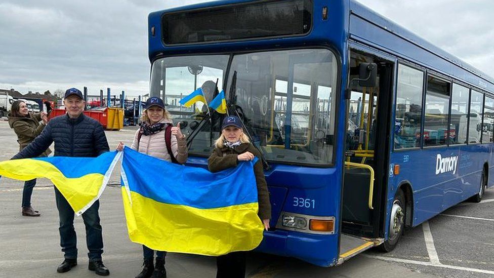 Members of the Swindon Humanitarian Aid Partnership standing in front of the bus