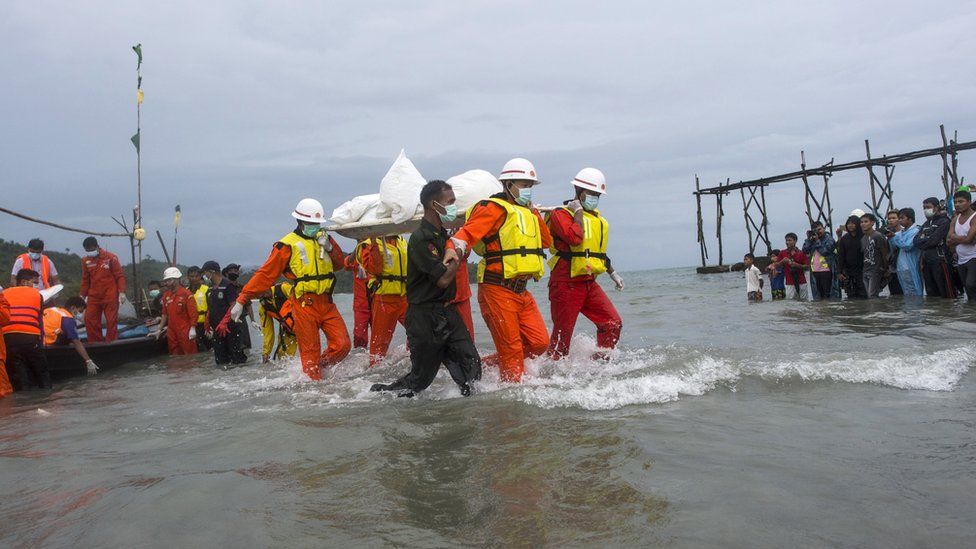 Myanmar rescuers recover a body from the plane crash in the Andaman Sea, on 8 June 2017