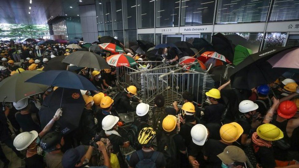 Protesters try to break into the Legislative Council building during the annual 01 July pro-democracy march in Hong Kong