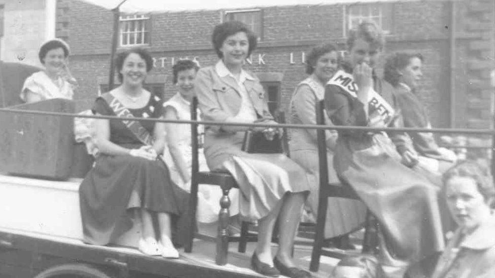 Coal queens riding on a float on picnic day