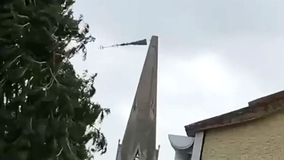 A still from a video showing the top section of the spire at St Thomas's Church in Wells, Somerset, falls to the ground due to strong winds from Storm Eunice on 18 February 2022