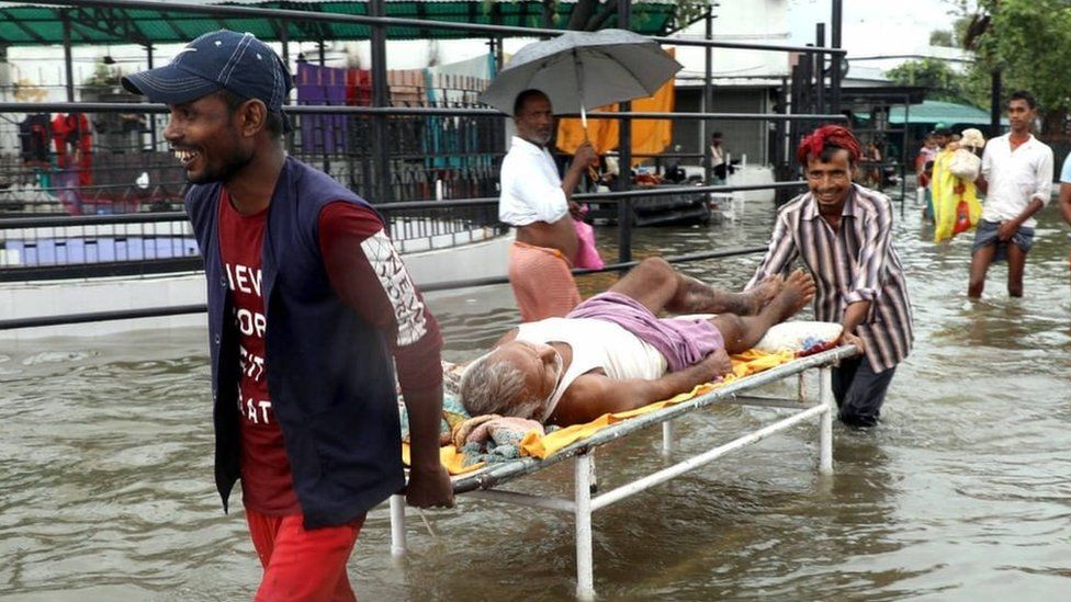 People navigate flooded streets in Bihar