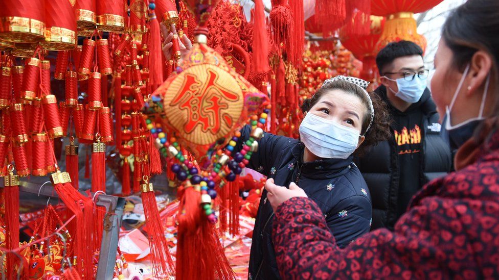 Shoppers wearing clinical masks shop for festive items to celebrate the Lunar New Year