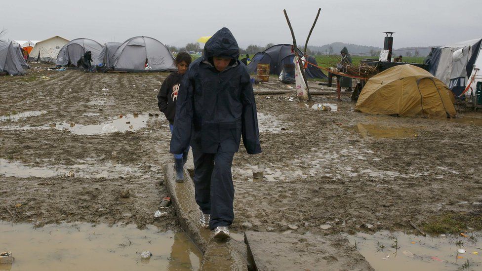 Boys walk at Idomeni camp near the Greek border with Macedonia