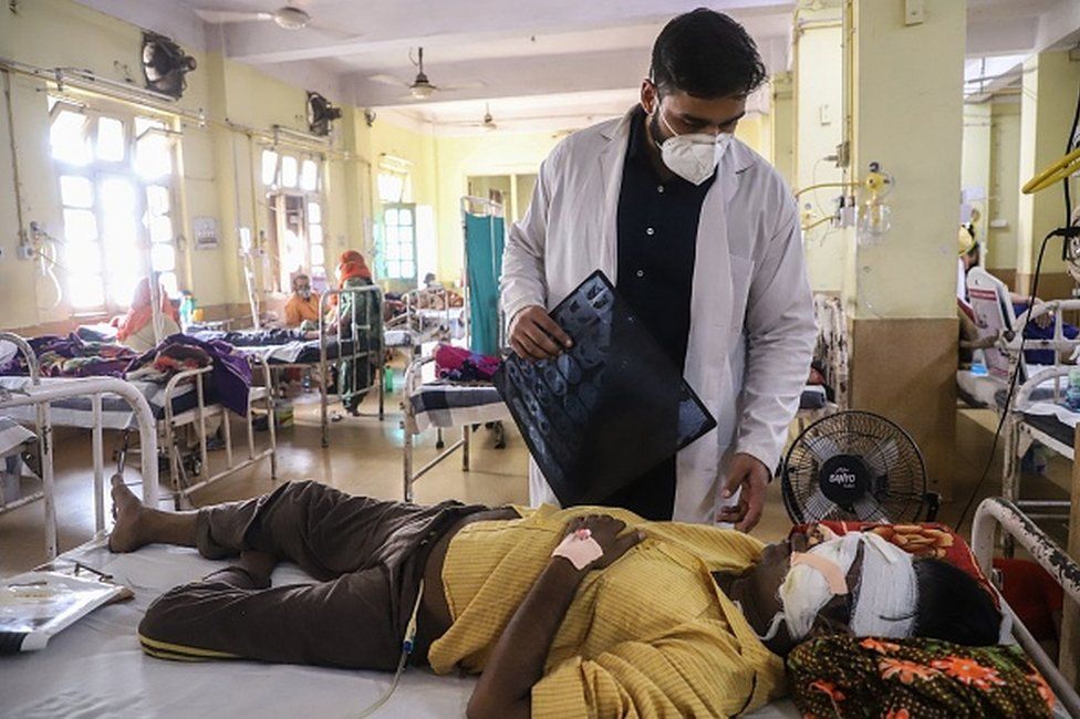 A doctor assists a Covid-19 coronavirus patient with Black Fungus, a deadly and rare fungal infection, as he receives treatments at the NSCB hospital in Jabalpur, on May 20, 2021.