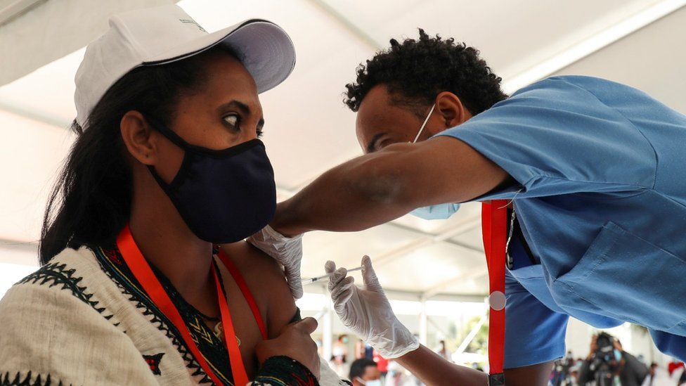 A woman receives the AstraZeneca/Oxford vaccine under the COVAX scheme against the coronavirus disease (COVID-19) at the Eka Kotebe General Hospital in Addis Ababa, Ethiopia March 13, 2021.