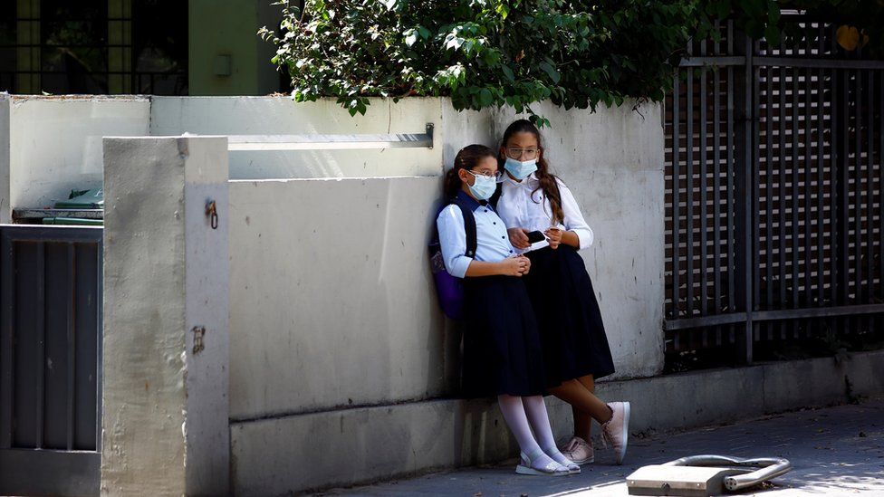 Girls wearing protective face masks look on in Tel Aviv, Israel September 15, 2020