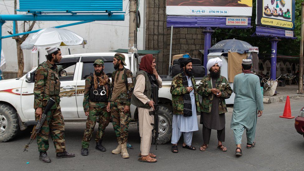 Taliban fighters stand at a checkpoint in Kabul, September 2022