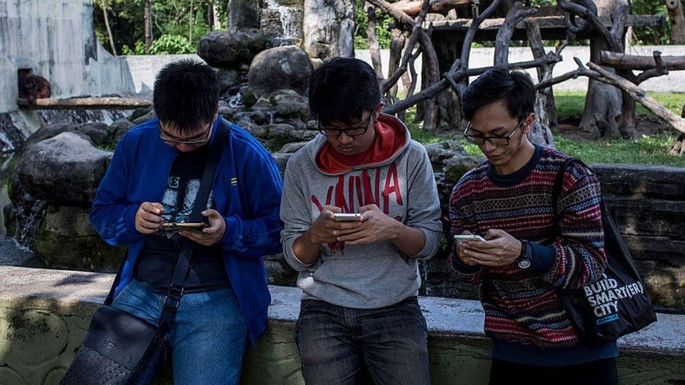 Young people on their phones in Yogyakarta Indonesia, 2016