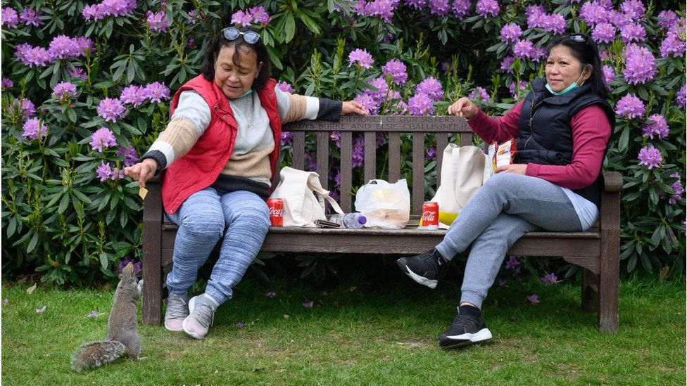 Two women picnic in Golders Hill Park