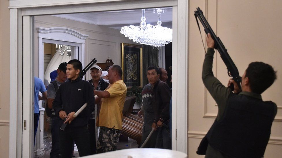 Supporters of former president Almazbek Atambayev guard his house as members of the special forces try to detain him outside the capital Bishkek on August 7, 2019