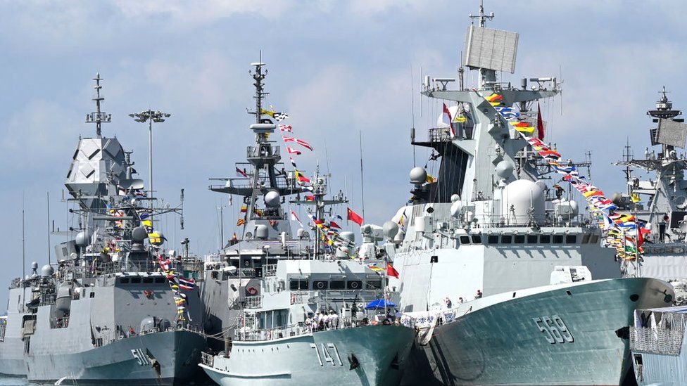Chinese Navy missile frigate Yulin (R) and the minesweeper hunter Chibi (C) are seen docked at Changi Naval Base during the IMDEX Asia warships display in Singapore on May 4, 2023