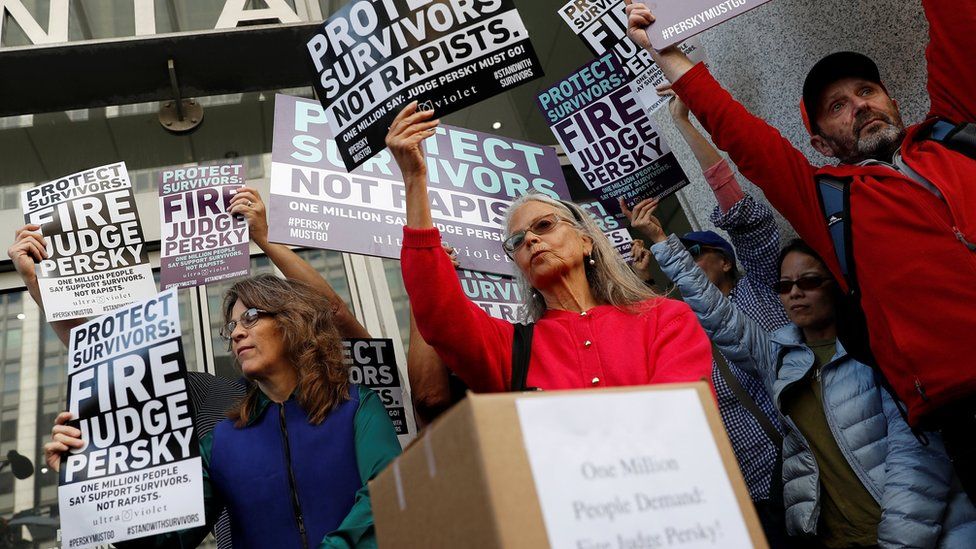 Activists hold signs calling for the removal of Judge Aaron Persky from the bench after his controversial sentencing in the Stanford rape case, in San Francisco, California, on 10 June