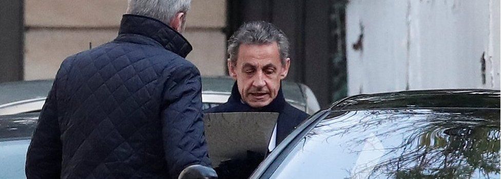 Former French President Nicolas Sarkozy enters his car as he leaves his house in Paris, 21 March 2018