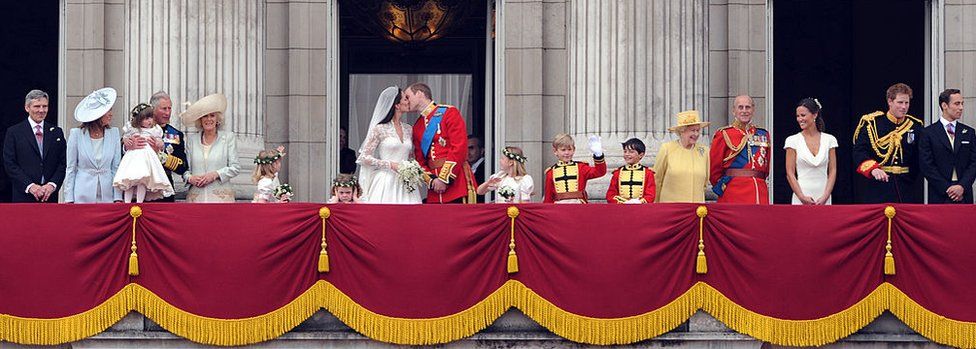 Britain's Prince William kisses his wife Kate, Duchess of Cambridge, on the balcony of Buckingham Palace, after the wedding service, in London, 29 April 2011