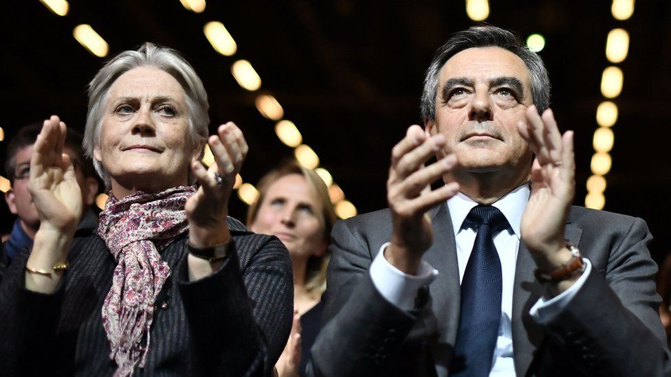 File image taken on 25 November 2016 shows Francois Fillon (R), candidate for the right-wing primaries ahead of the French 2017 presidential election, with his wife Penelope attending a campaign rally in Paris, ahead of the primary's second round on