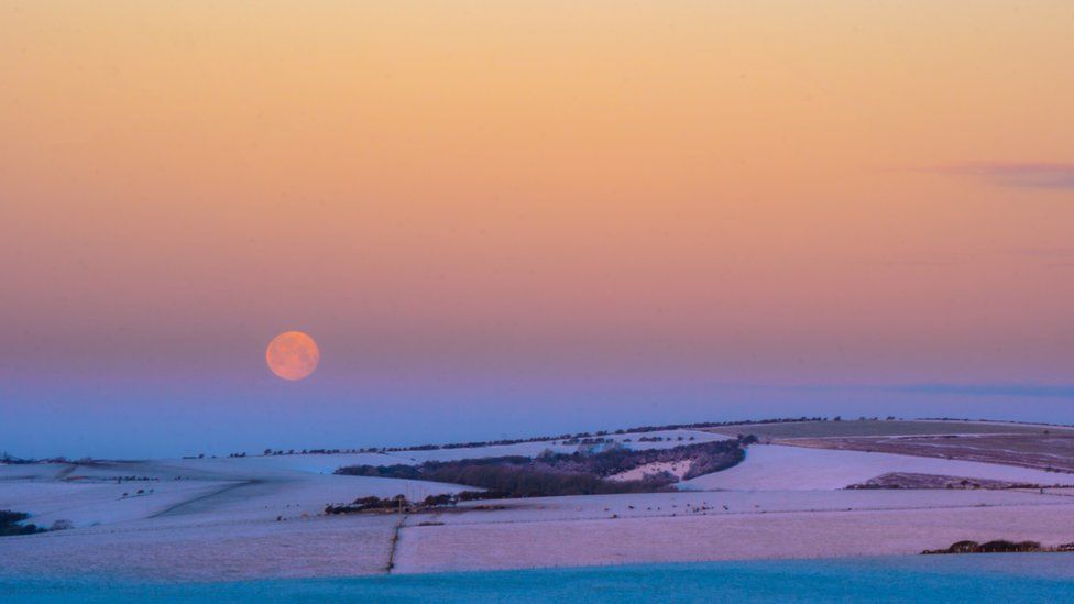 The moon over snow covered fields