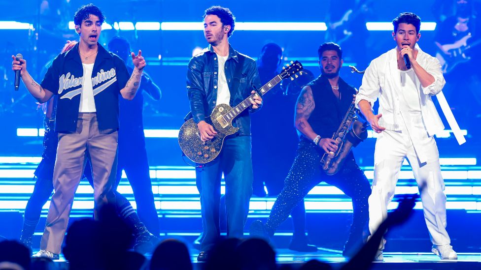 Joe Jonas, Kevin Jonas, and Nick Jonas perform onstage during Jonas Brothers "Five Albums, One Night" Tour at Little Caesars Arena on August 24, 2023 in Detroit, Michigan