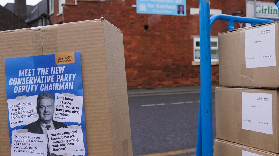 A box of leaflets showing headlines about Lee Anderson