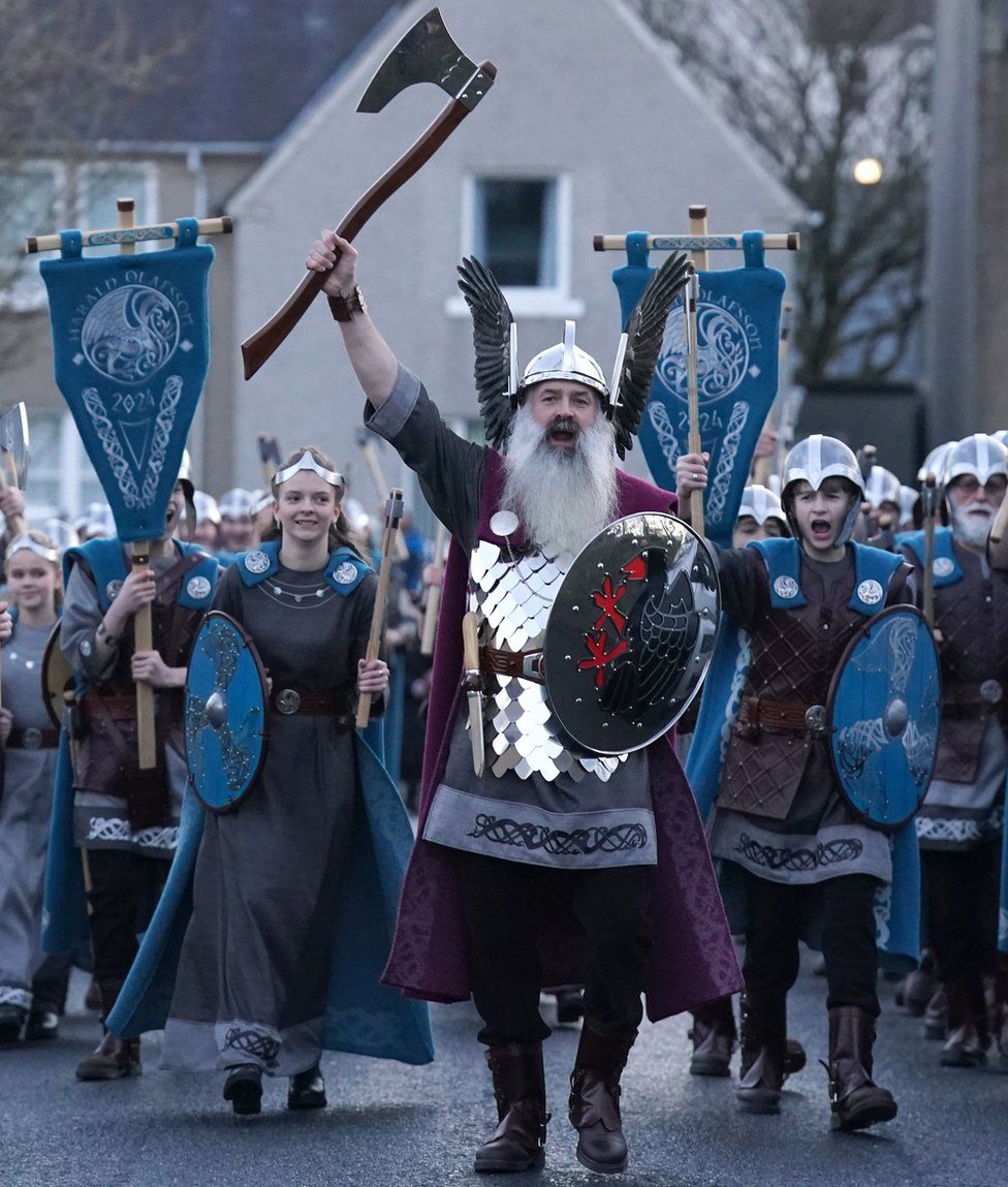 Guizer Jarl Richard Moar leads the first mixed-sex Jarl Squad through Lerwick