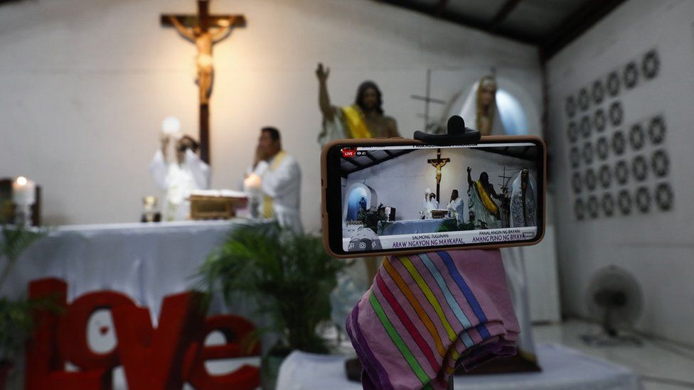 A smartphone is used for online streaming of a Catholic mass to mark Easter Sunday at a church in Quezon City, Metro Manila, Philippines