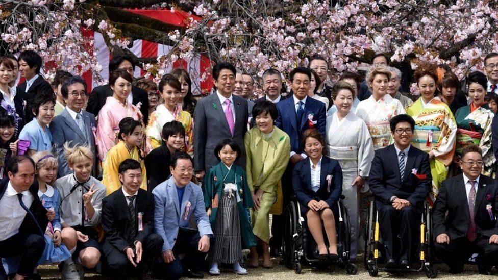 Prime Minister Shinzo Abe (centre left) posing with entertainers and athletes during the cherry blossom viewing party hosted by the prime minister in 2017