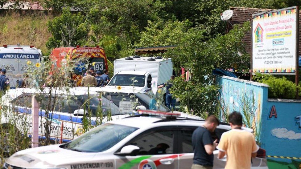 A view shows forensic technicians, ambulances and policemen outside a pre-school after a 25-year-old man attacked children, killing several and injuring others, according to local police and hospital, in Blumenau, in the southern Brazilian state of Santa Catarina, Brazil April 5, 2023.
