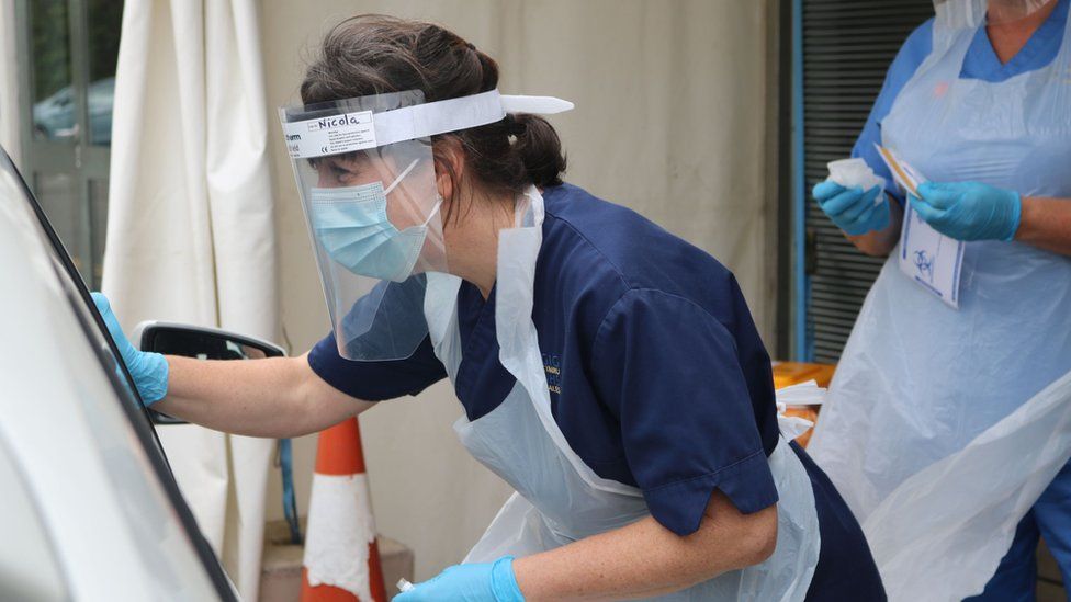 A nurse at a drive-through testing centre in Gwynedd