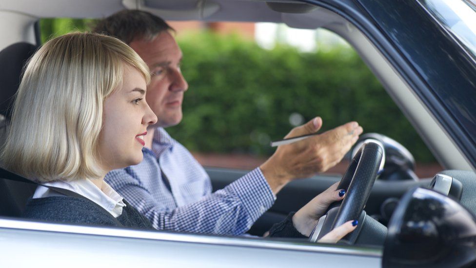Woman with driving instructor