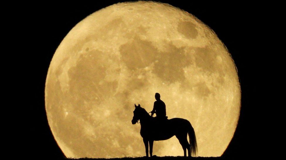 Jonay Ravelo and his horse Nivaria observe the super moon known as the Blue Moon, from a mountain in Mogan, in the south of the island of Gran Canaria, Spain, August 31, 2023.