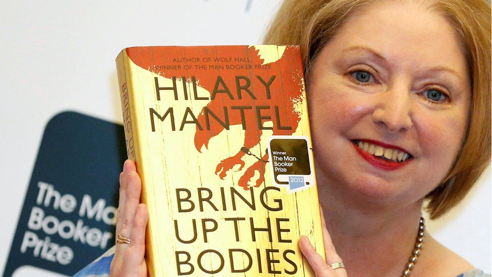 Dame Hilary with a copy of her novel Bring Up The Bodies