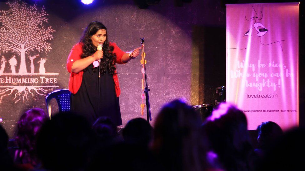 Comedian Sumukhi Suresh performing at a comedy club