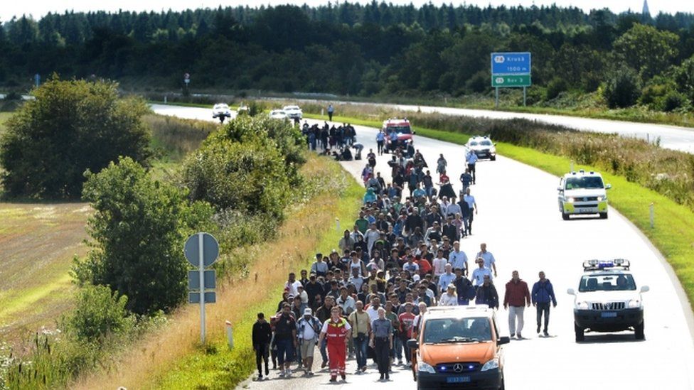 Migrants walk on the E45 freeway at Padborg, while trying to head to Sweden September 9, 2015