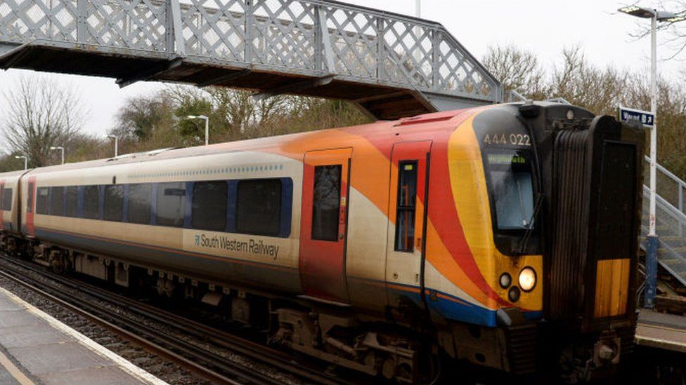 UK train services cut due to Covid staff absences - BBC News