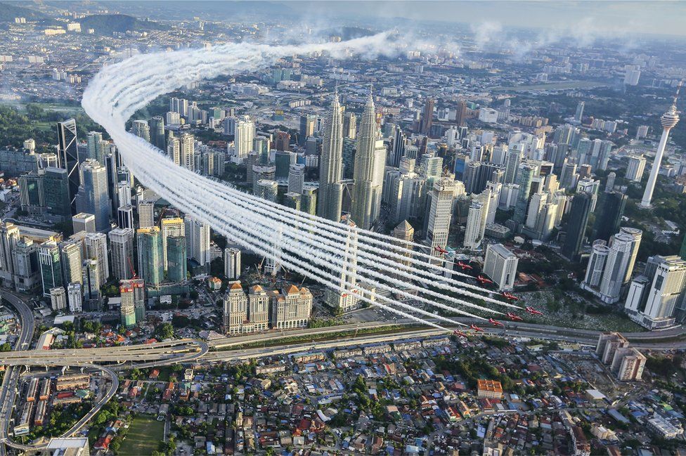 Red Arrows perform a flypast over Kuala Lumpur city centre around the Petronas towers