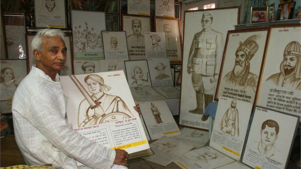 Ravi Chander Gupta with the paintings of freedom fighters, made out of his own blood at his residence in New Delhi on Wednesday, August 16, 2006