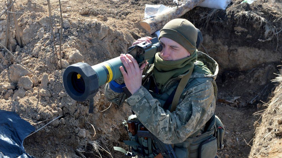 A serviceman of Ukrainian military forces holds a light anti-tank rocket launcher at a checkpoint, where they hold a position near Kharkiv on March 23, 2022.