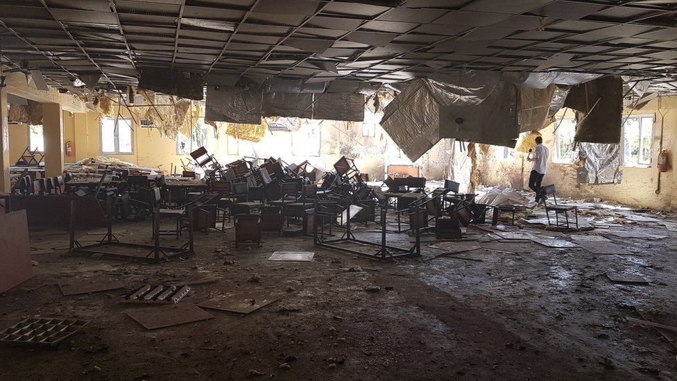Overturned tables and chairs inside army base