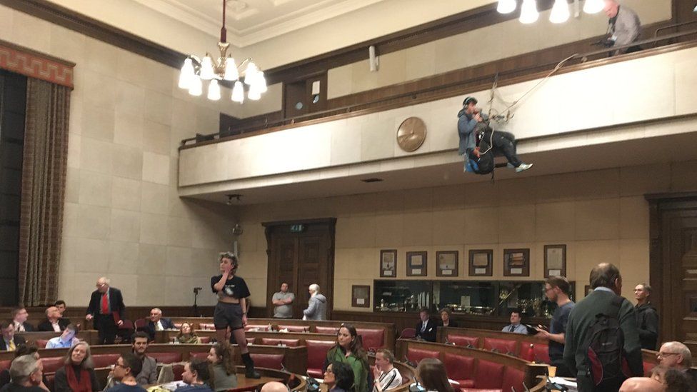 Cambridge City Council chamber and protesters