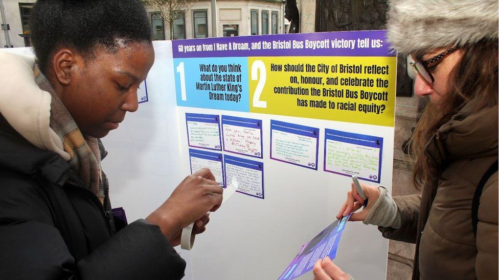 People adding their opinions to a ballot box