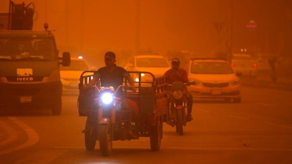 Vehicles drive along a road during a severe dust storm in Iraq's capital Baghdad