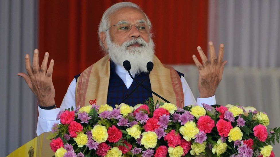 Indian Prime Minister Narendra Modi gestures as he addresses a public meeting at Jerenga Pathar in Sivasagar district of India's Assam state on January 23, 2021.