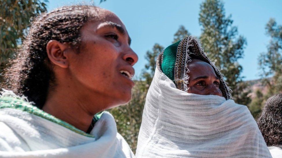 Women mourn the victims of a massacre allegedly perpetrated by Eritrean Soldiers in the village of Dengolat, North of Mekele, the capital of Tigray on February 26, 2021