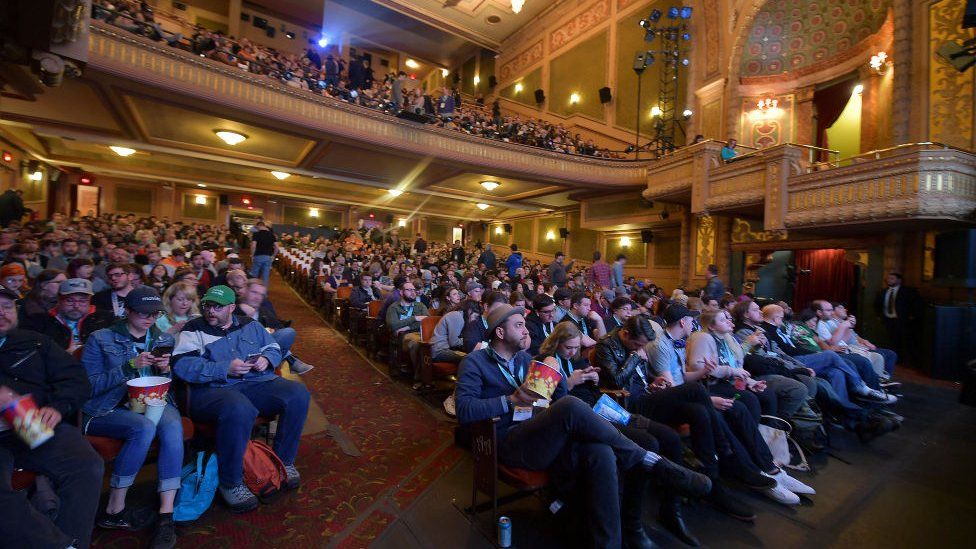 An audience watches a screening of a new film at SXSW