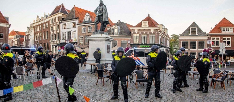 Police stands guard around the statue of Jan Pieterszoon Coen in Hoorn, on June 19, 2020
